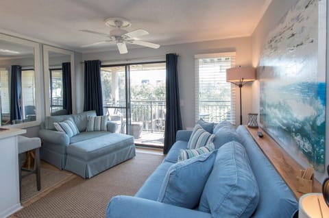 Living Room has a queen sleeper sofa, oversized chair, and TV.