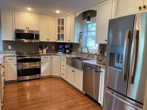 Stocked kitchen with a crock pot, air fryer, and cleaning supplies.