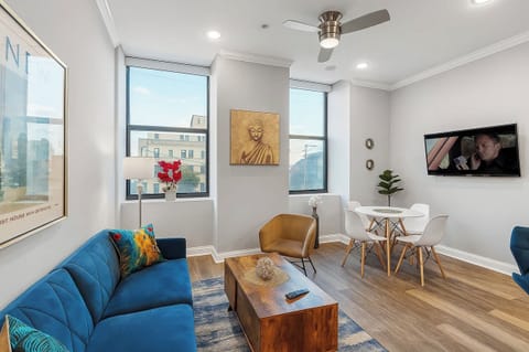 Bright, open-concept living space with smart motorized shades, comfortable seating, and 43" smart TV—your perfect Philadelphia home base.