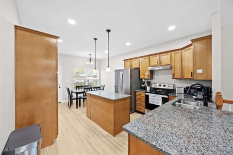 Kitchen: A modern kitchen with granite countertops and stainless steel appliances.