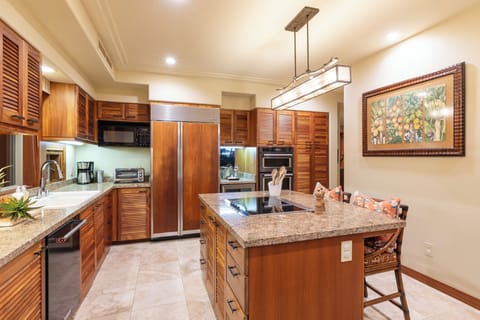 Warm wood cabinetry and high-end appliances create an inviting culinary space.