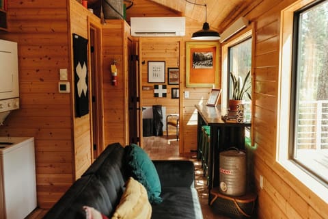 Open concept living room and kitchen leave you immersed in the outdoor forest surroundings. 