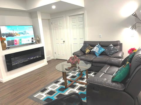 Living room with Smart TV, Electric fireplace and central suite heating controls