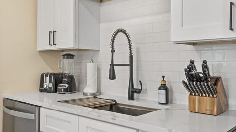 Cocoa Beach Kitchen | Bright coastal design with open shelving, subway tile, and modern stainless finishes.