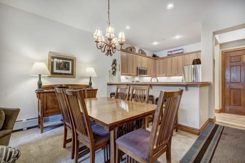 Spacious dining area adorned with a charming chandelier, ideal for family meals and gatherings.