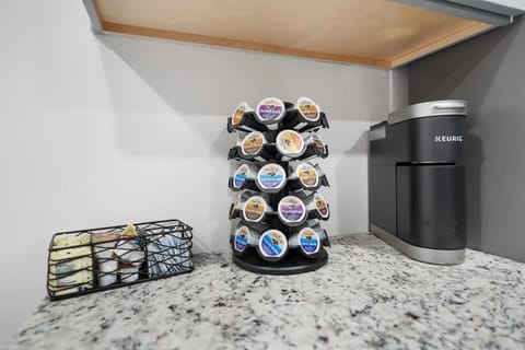 Grab your morning coffee from the coffee station with Keurig coffeemaker, supply of K-cups, and additional hot-beverage supplies.
