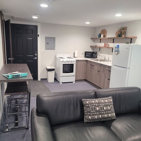 Toaster oven, hot plate, coffee pot, frig, microwave, wine opener, pizza cutter, dishes, silverware, coffee cups, etc.