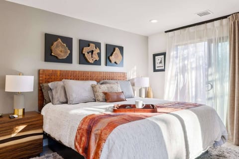Retreat to the master bedroom, where blackout shades, luxury bedding, and elegant furnishings create the ultimate sanctuary for rest and relaxation.