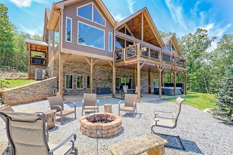 Outdoor fire pit, tree with twinkle lights, patio, hot tub, rower and weights.  