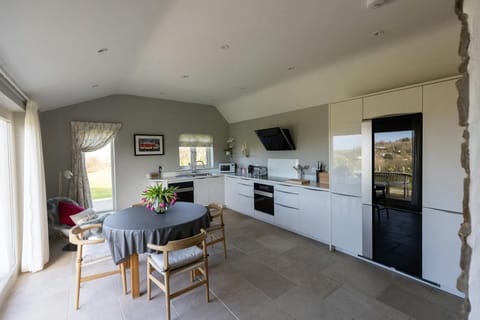 Kitchen: dining table with four chairs, patio doors leading to the garden
