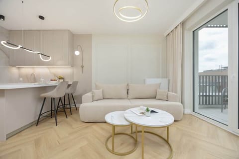 Living room with a cream-colored sofa, a round coffee table, and a soft, neutral color palette.