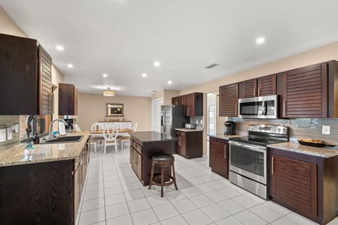 Chef's kitchen offers stainless steel appliances, granite countertops and a pantry