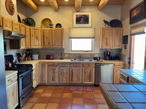 Kitchen with wood cabinets and Satlillo tiles