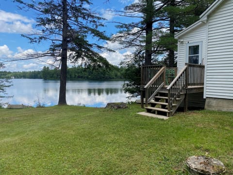 View from the yard showing back deck and lakefront.