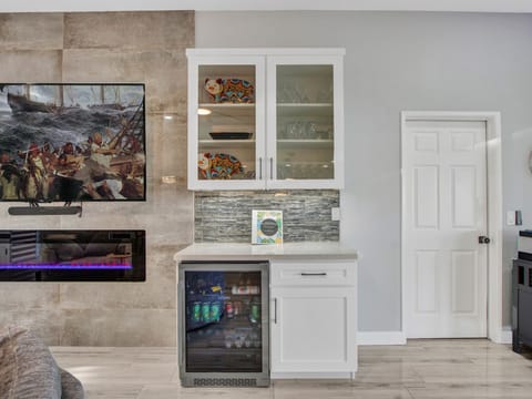 Beverage fridge and nice collection of drinking glasses for any type of beverage