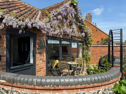 Courtyard now has small wicker fence on wall for privacy