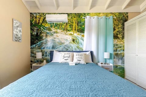 Rest in a peaceful waterfall-themed bedroom inspired by the natural beauty of nearby Dunn’s River Fa