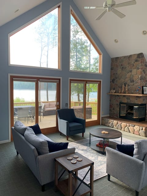 Living room with fireplace, beautiful views of Green Lake and access to deck