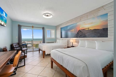 Furnished with two full-size beds, a desk, and two chairs.
