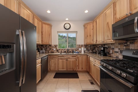 - Fully equipped kitchen with modern appliances   - Rustic wood cabinets and scenic window views   - Great for cooking meals after mountain adventures