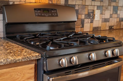 - Modern gas stove with granite counters and backsplash   - Fully equipped kitchen for cooking family meals   - Perfect setup for cozy nights in the mountain cabin