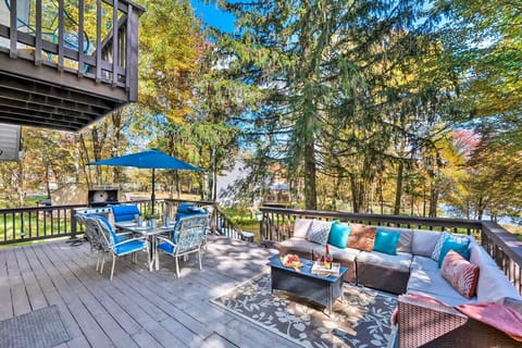 Spacious and inviting, the back deck features a cozy seating area, dining table and a grill. Perfect for gathering the whole group for outdoor meals and fun