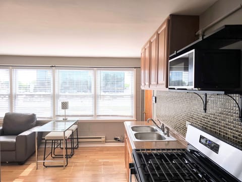 climate control, couch, stovetop, kitchen, microwave and full refrigerator 