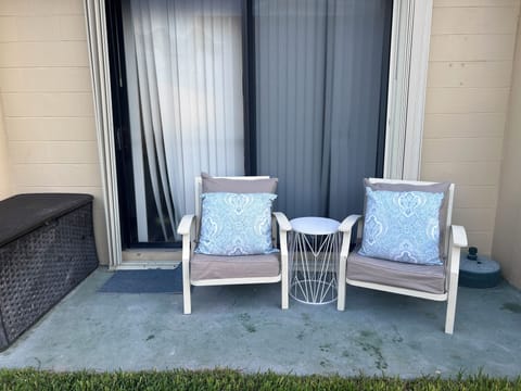 Cozy outdoor patio faces tennis courts.