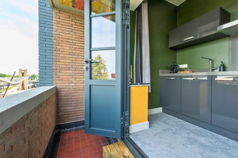 Step out from the kitchen onto this bright Tilburg balcony — perfect for fresh air, morning sunlight, or a quiet coffee break