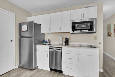 Your fully equipped kitchen features stainless steel appliances and bright white cabinets, perfect for preparing meals during your stay.