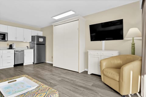 Unwind in your modern studio with full kitchen, smart storage, and cozy seating after exploring.