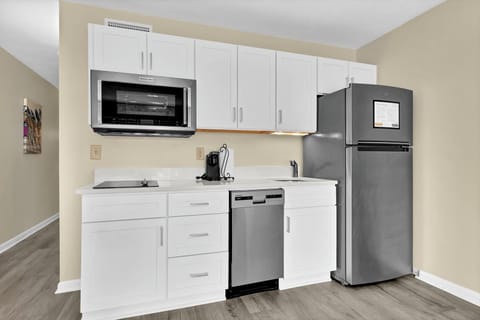 Your sleek kitchenette features modern appliances and ample cabinet space for preparing meals during your stay.