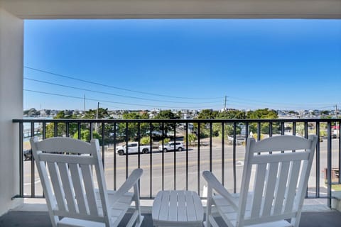 Relax in your comfortable Adirondack chairs on this private balcony, perfectly positioned for enjoying the peaceful view and morning coffee.