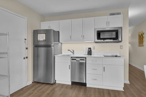 Your fully equipped kitchen awaits with stainless appliances, crisp white cabinets, and everything needed for home-cooked meals.