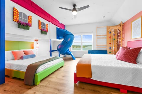 Welcome to COLORS OF BRANSON—a bold, playful retreat designed for families, complete with a custom bunk room, indoor slide, and backyard playset.