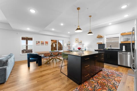 Open Concept Kitchen + Dining + Living Space with views of the Lake