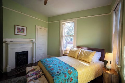 Queen size bed with north and east facing windows.