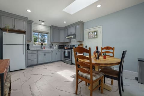 **Modern and Fully-Equipped Kitchen**  Step into our modern kitchen, complete with all the essentials you need for a comfortable stay. Featuring sleek appliances, ample counter space, and a large window for natural light, it`s perfect for cooking meals or