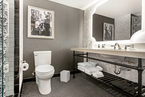 Refresh effortlessly with bright vanity lighting and plush folded towels.