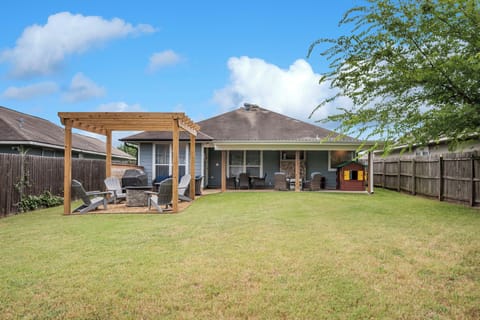 Huge backyard with lots of entertaining space and custom arbor with firepit.