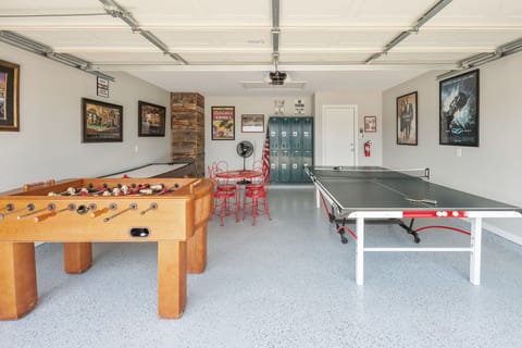 Game Room with foosball, air hockey, and a ping pong table with vintage seating