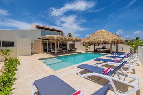 The huge outside area offers a pool, outside furniture, palapa, & a BBQ grill.