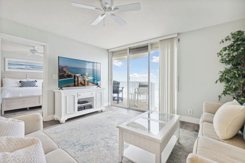 Bright and airy living room with a direct ocean view and a spacious balcony.