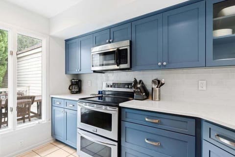 The kitchen is well-stocked and looks onto the front deck