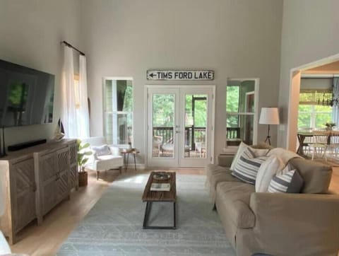 Bright, open living room with vaulted ceiling, and comfy down & foam sofa.