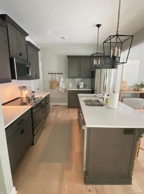 Fully stocked kitchen with large island and beautiful quartz countertops.
