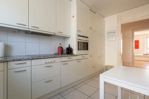 Bright and spacious kitchen with a big window and ample storage space -  fully equipped with dishwasher, fridge, microwave, oven, toaster, Nespresso coffee machine etc. 

A cozy table for casual dining or as additional tabletop space.