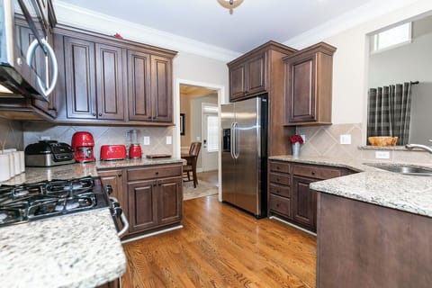Modern, fully equipped kitchen with ample counter space—bright, functional, and ready for home-cooked meals.