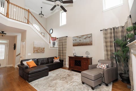 With its dramatic high ceilings and elegant gas fireplace, this spacious living room combines comfort and style—perfect for relaxing evenings or lively gatherings.