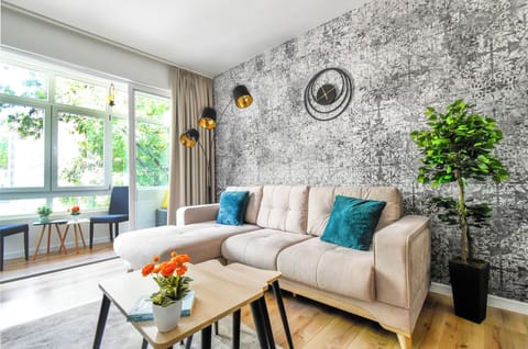 Relax and recharge in this stylish living room. With its modern design and comfortable seating, it's the perfect place to unwind after a day of exploring. Book your stay today and make yourself at home!